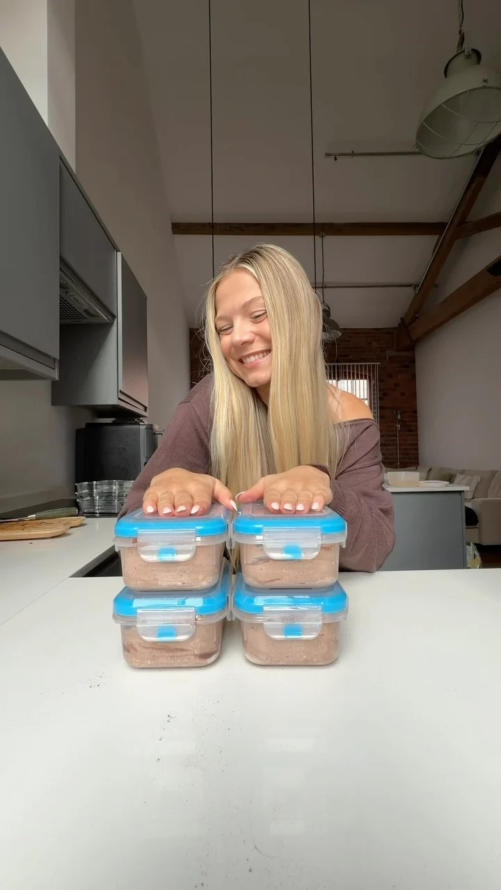 Becky with her meal prep containers in the chocolate overnight oats episode